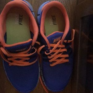 Blue, & orange women’s Nike free tennis shoe.